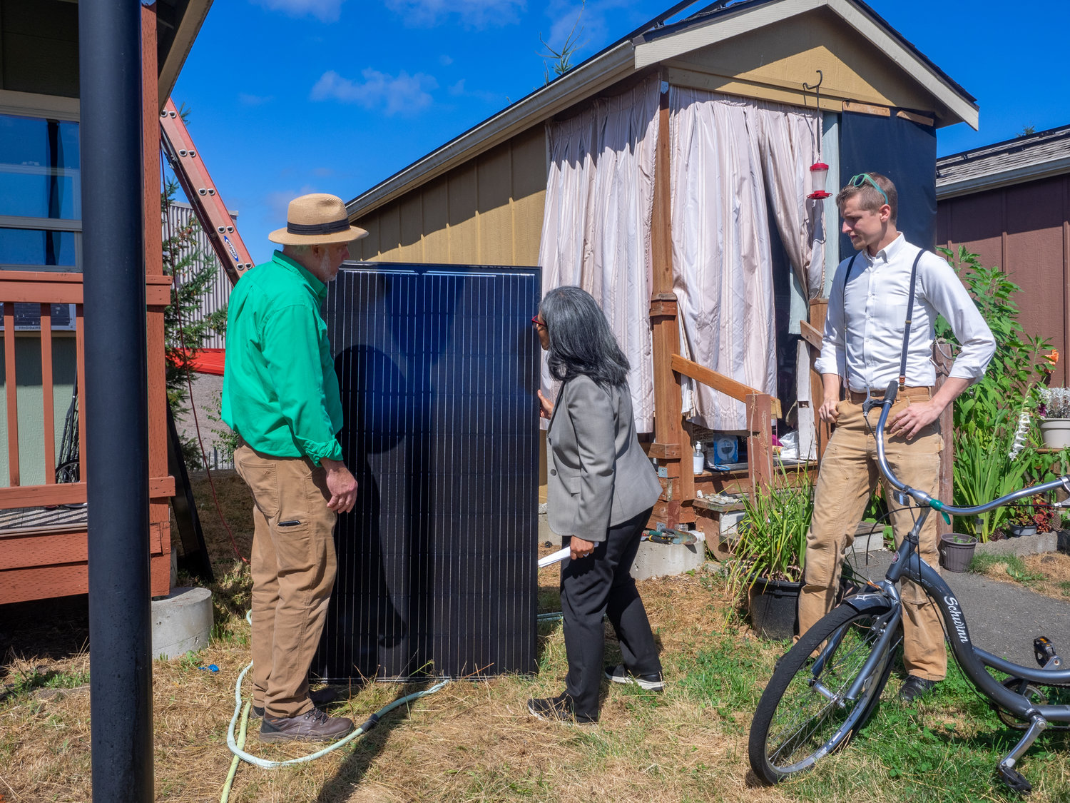 Kirk Haffner, president of South Sound Solar, talks with Congresswoman Strickland and , Mason Rolph of Olympia Community Solar about the installation at Quixote Village on August 2, 2022.